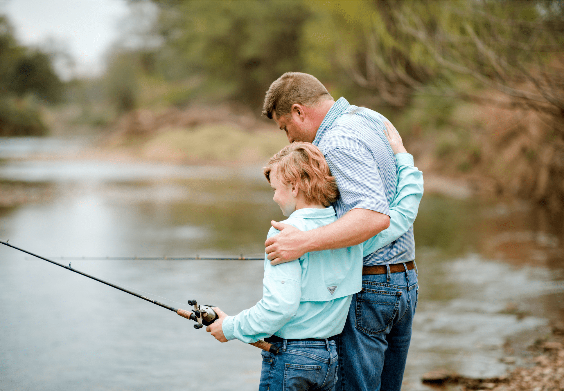 A man and child fishing, representing generations.